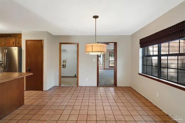 a view of a room with window and refrigerator