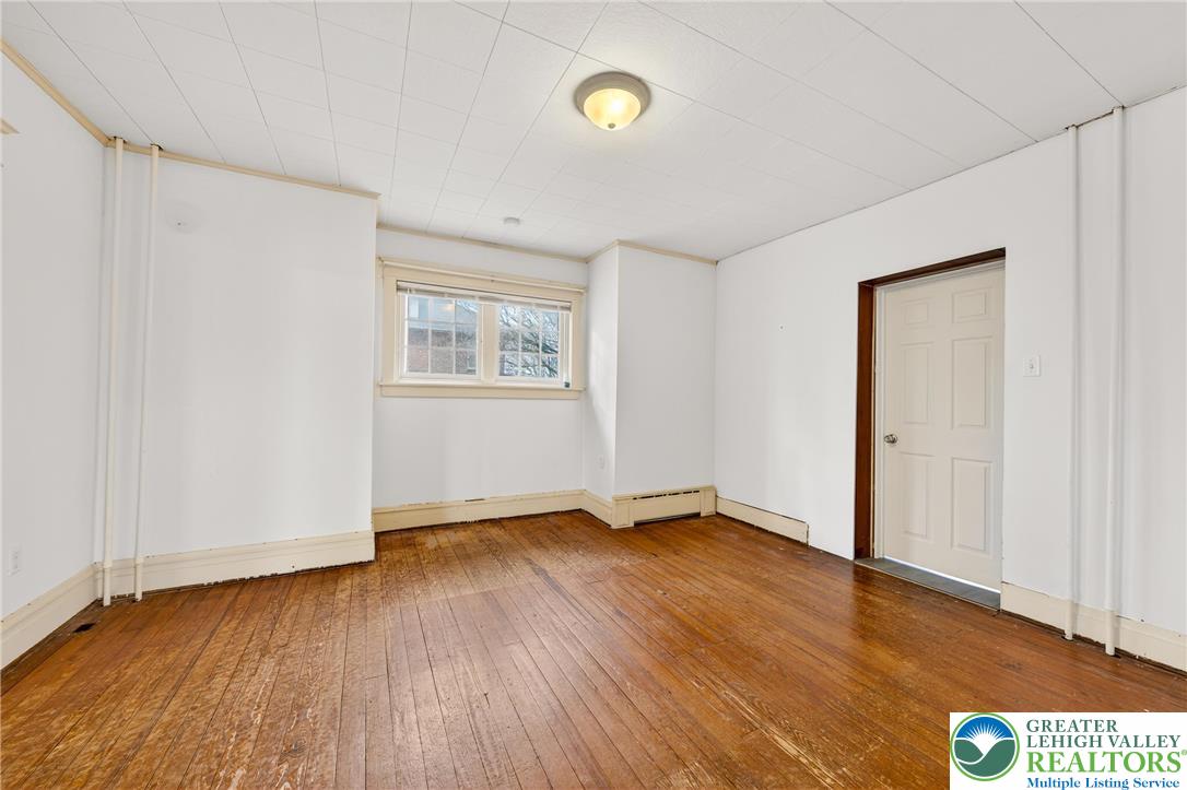 3301 Lehigh Street Whitehall, PA 18052 - Photo 16 of 40 a view of an empty room with wooden floor and a window
