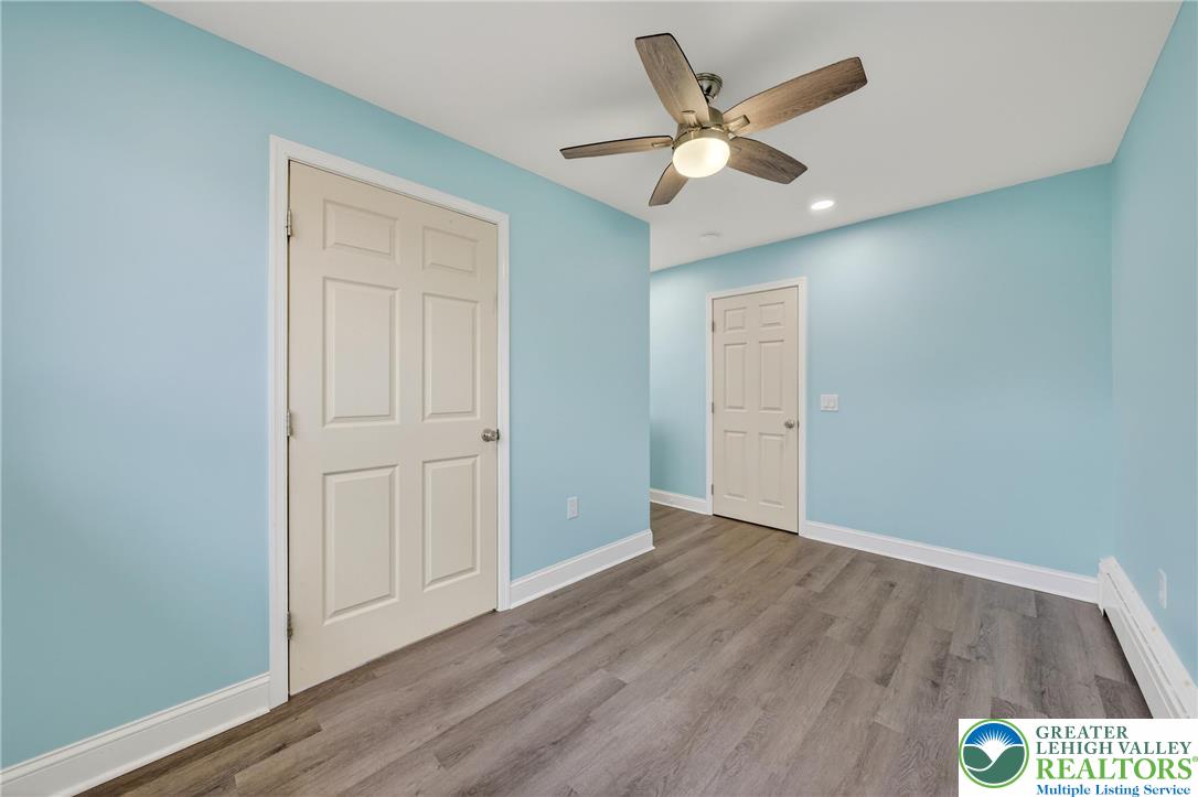 3301 Lehigh Street Whitehall, PA 18052 - Photo 19 of 40 an empty room with wooden floor and ceiling fan