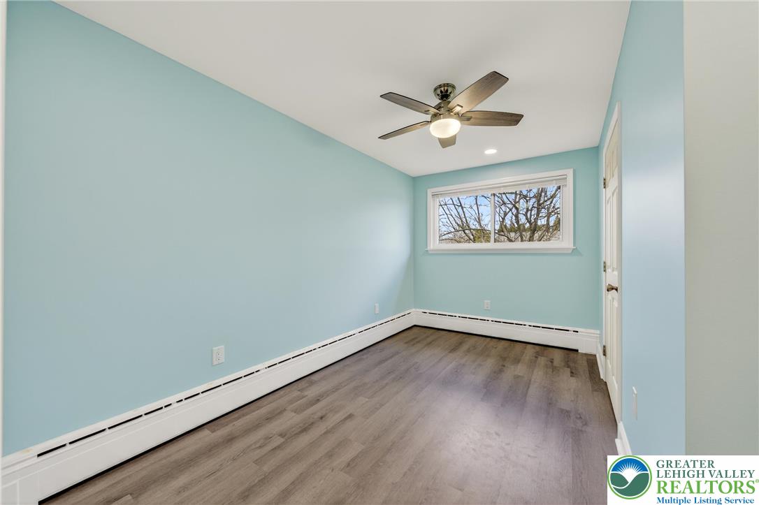 3301 Lehigh Street Whitehall, PA 18052 - Photo 31 of 40 an empty room with wooden floor fan and windows