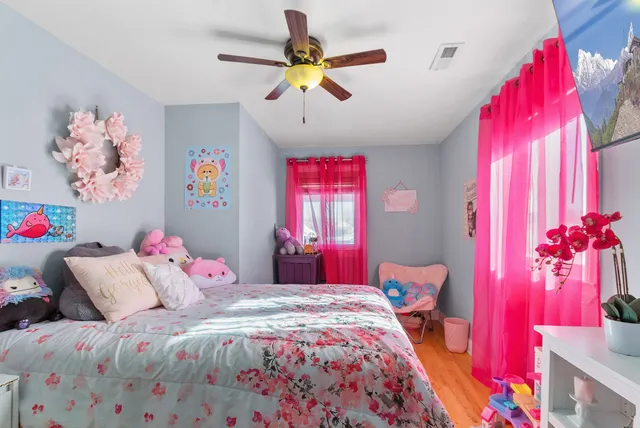 a bedroom with a bed and a chandelier