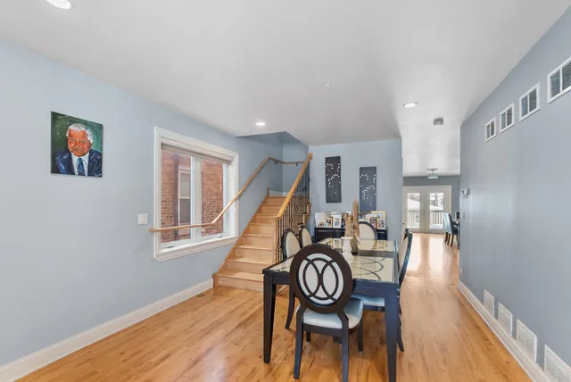 a dining room with furniture a window and wooden floor