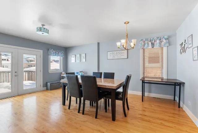 a view of a dining room with furniture window and wooden floor