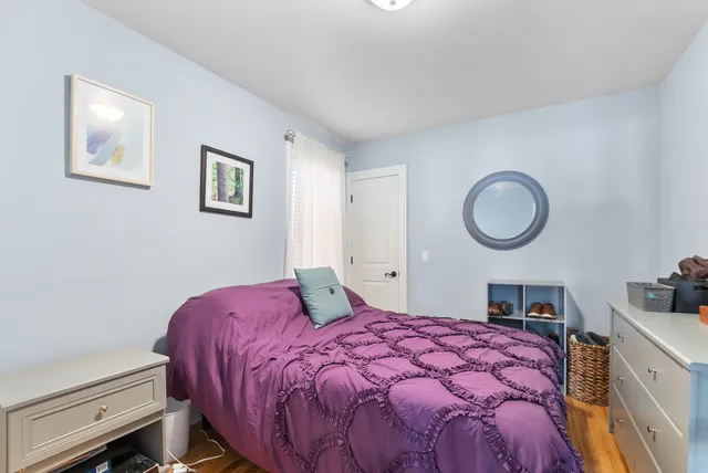 a bedroom with a bed and a lamp with window