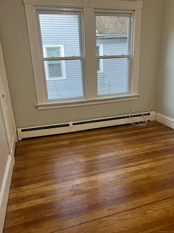 a view of a room with wooden floor and windows