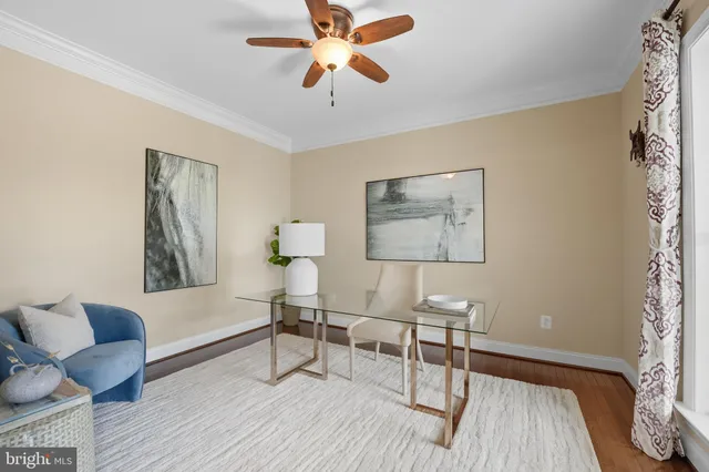 a living room with furniture a fireplace and a large window