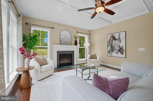 a kitchen with kitchen island granite countertop a stove a sink a center island and wooden floor