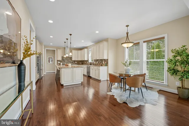 a kitchen with stainless steel appliances granite countertop a stove a sink and white cabinets