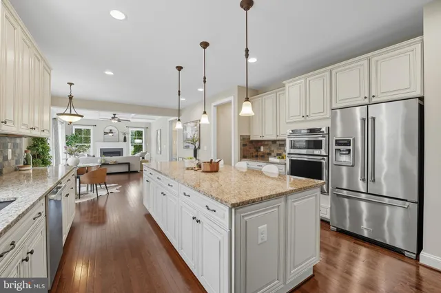 a view of a hallway with wooden floor and windows