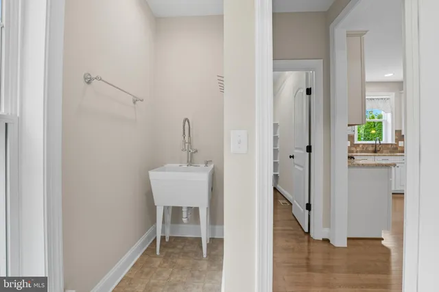 a bedroom with a large bed couch and a window