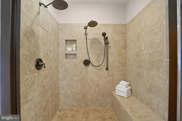 a view of walk in closet and empty room