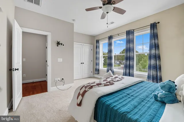 a bedroom with a bed and a painting on the wall