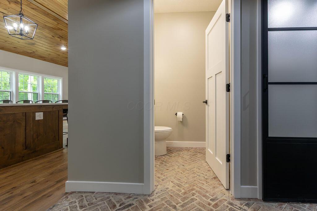 21650 Lake Road Glouster, OH 45732 - Photo 43 of 77 Half bath off mudroom with custom brick flooring