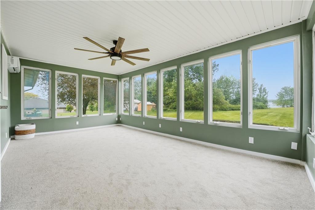 17 Shenango Road New Castle, PA 16105 - Photo 5 of 16 a view of an empty room with a fireplace and a large window with outer view