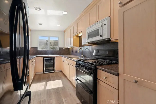 a kitchen with a refrigerator and a sink