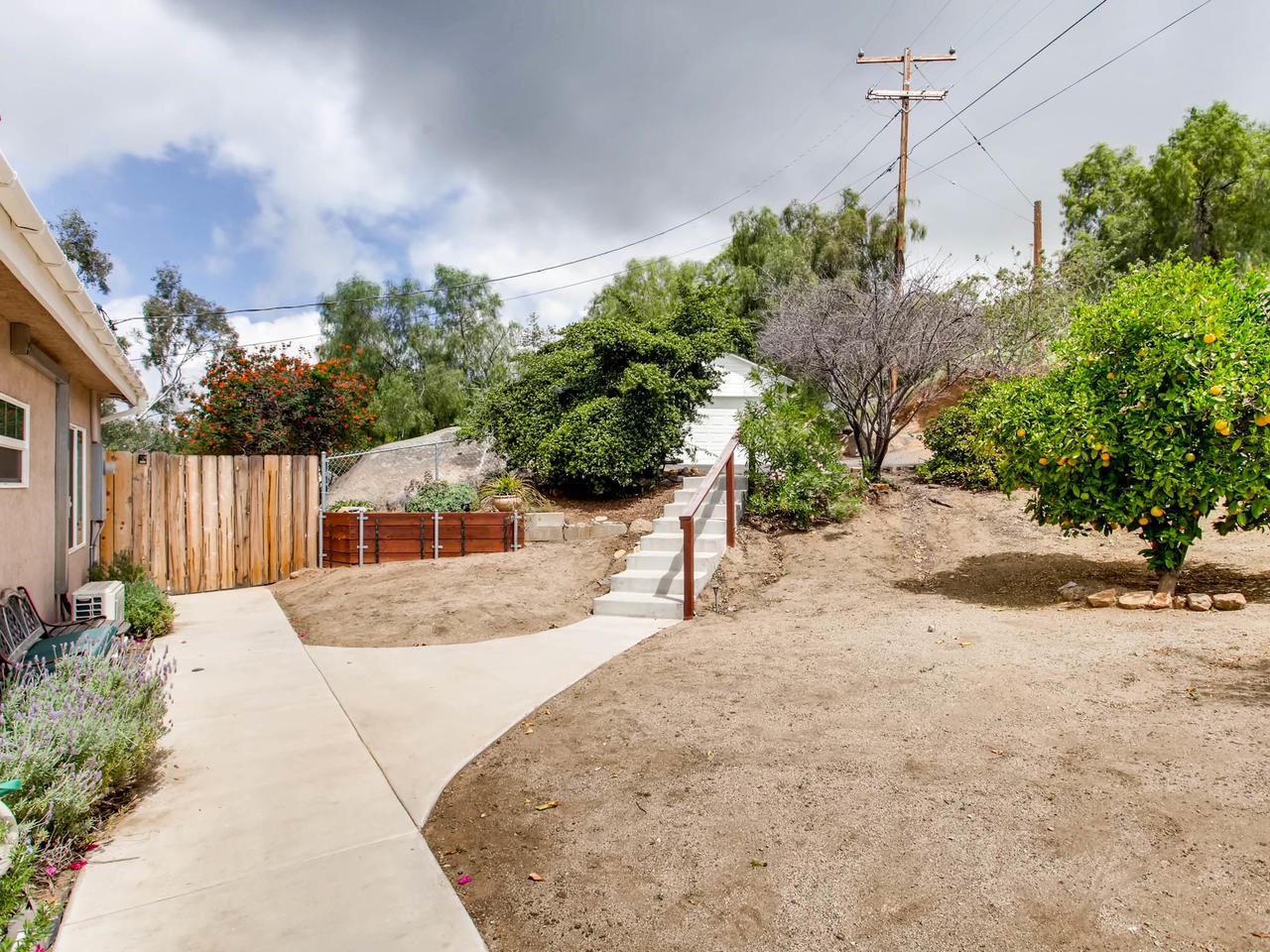 740 Coyote Road Alpine, CA 91901 - Photo 4 of 24 Exterior side of home with pathway to garage.