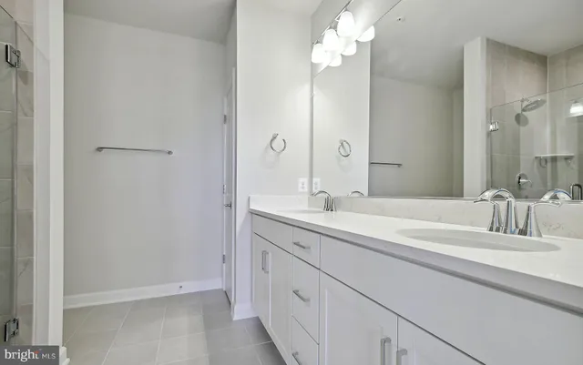 a bathroom with a granite countertop toilet a sink and a mirror