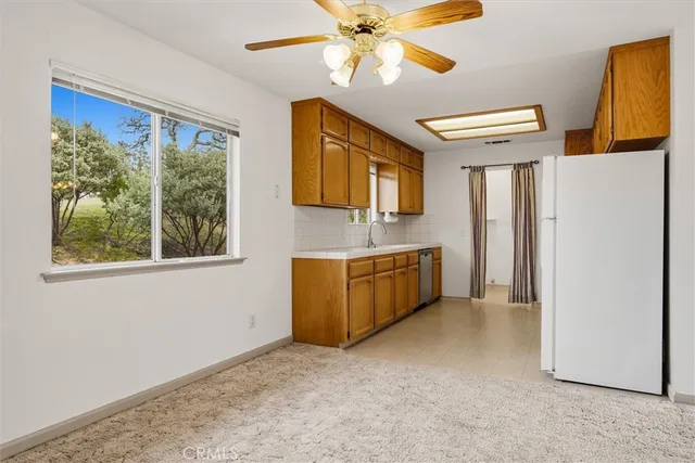 a kitchen with a refrigerator a stove top oven