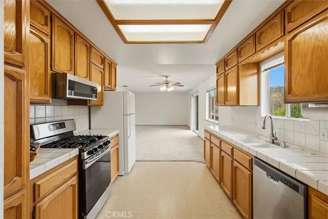 a bathroom with a granite countertop sink toilet a large mirror and shower