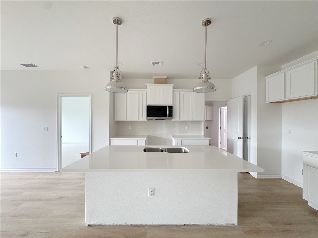 2105 Fury Portland, TX 78374 - Photo 11 of 23 a view of a kitchen with kitchen island a sink a counter top space and stainless steel appliances
