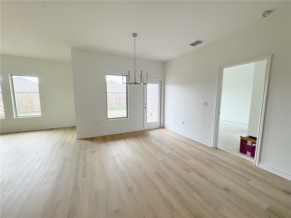 2105 Fury Portland, TX 78374 - Photo 12 of 23 an empty room with wooden floor and windows