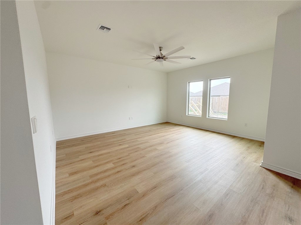 2105 Fury Portland, TX 78374 - Photo 13 of 23 an empty room with wooden floor ceiling fan and windows