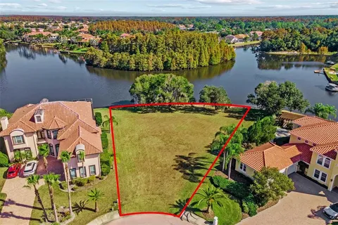 an aerial view of a house with a lake view