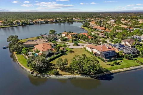 an aerial view of residential houses with outdoor space and ocean view
