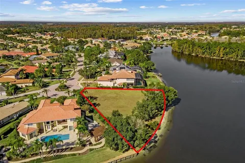 an aerial view of a house with a lake view