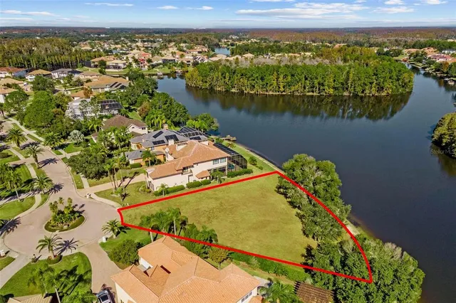 an aerial view of a house with a lake view