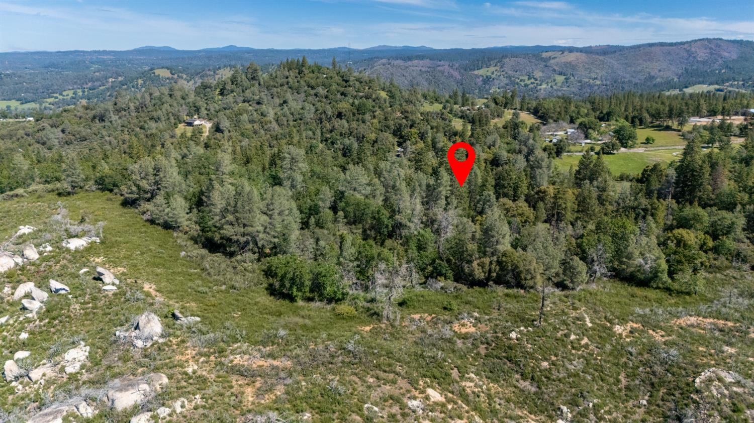 7220 Grizzly Flat Road Somerset, CA 95684 - Photo 23 of 28 a view of a lush green forest with mountains and a houses