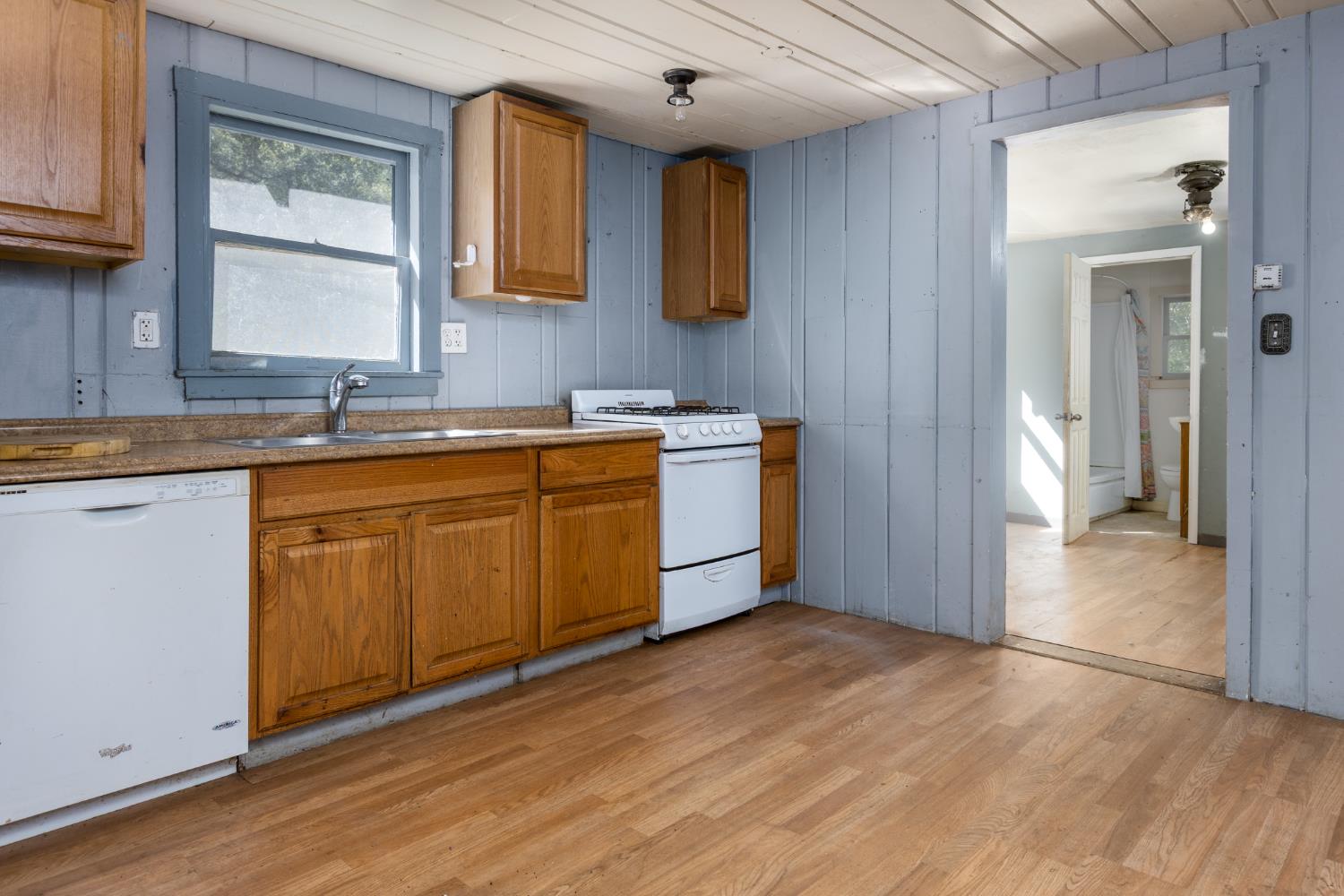 7220 Grizzly Flat Road Somerset, CA 95684 - Photo 7 of 28 a kitchen with stainless steel appliances granite countertop a sink cabinets and wooden floor