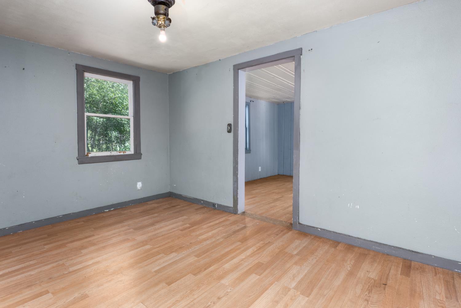 7220 Grizzly Flat Road Somerset, CA 95684 - Photo 8 of 28 wooden floor in an empty room with a window