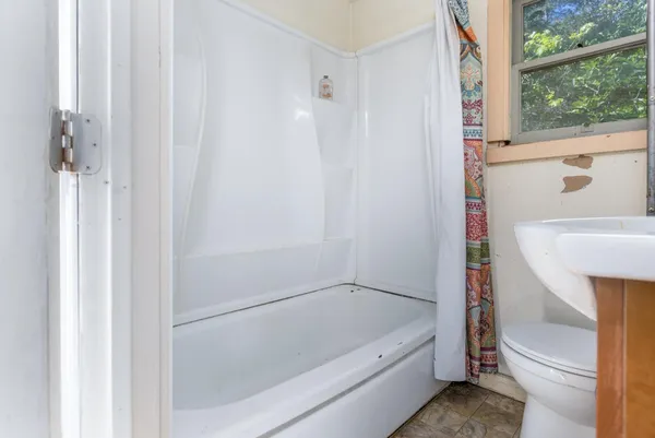 a bathroom with a tub and shower
