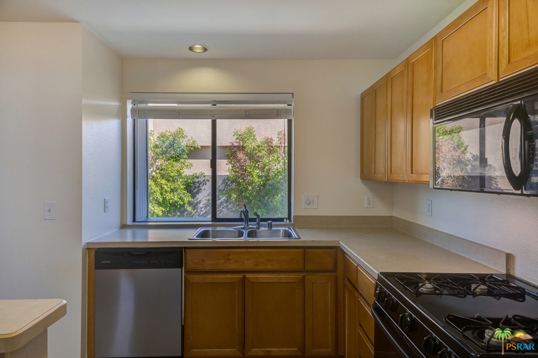 100 East Stevens Road, Unit 509 Palm Springs, CA 92262 - Photo 15 of 37 a kitchen with a sink a stove and a window