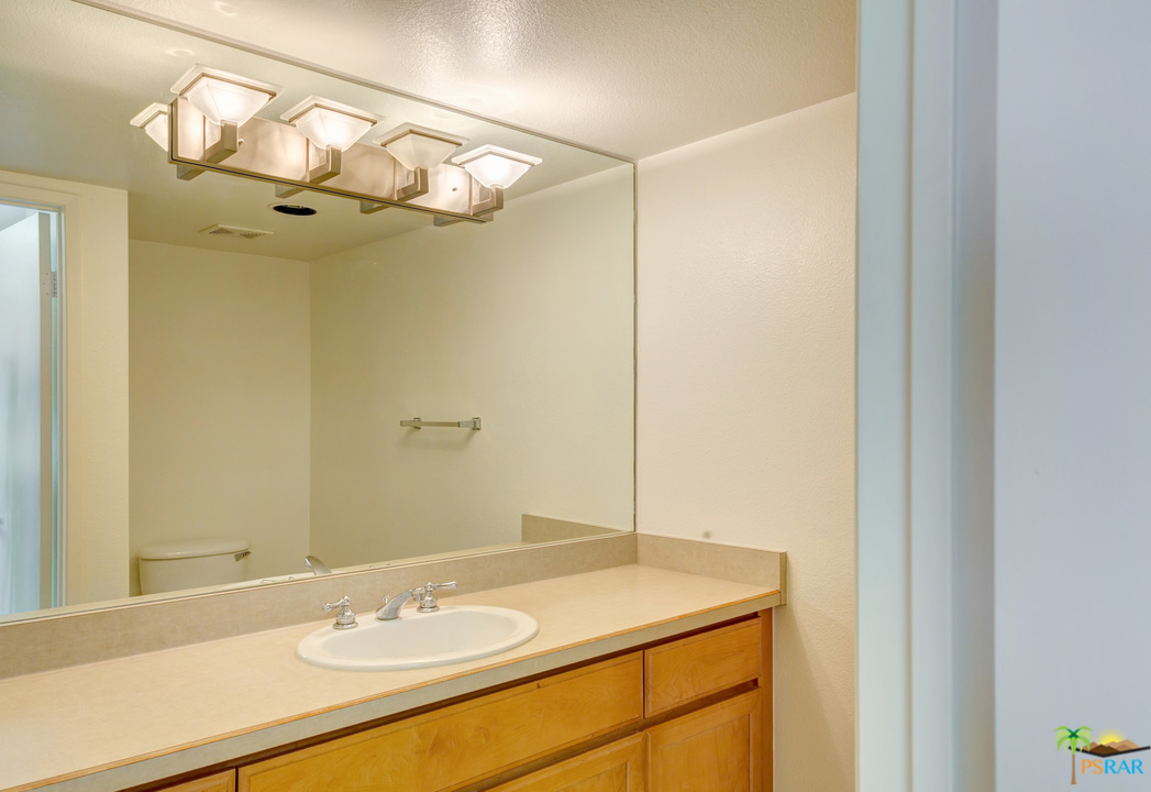 100 East Stevens Road, Unit 509 Palm Springs, CA 92262 - Photo 21 of 37 a bathroom with a granite countertop sink and a mirror