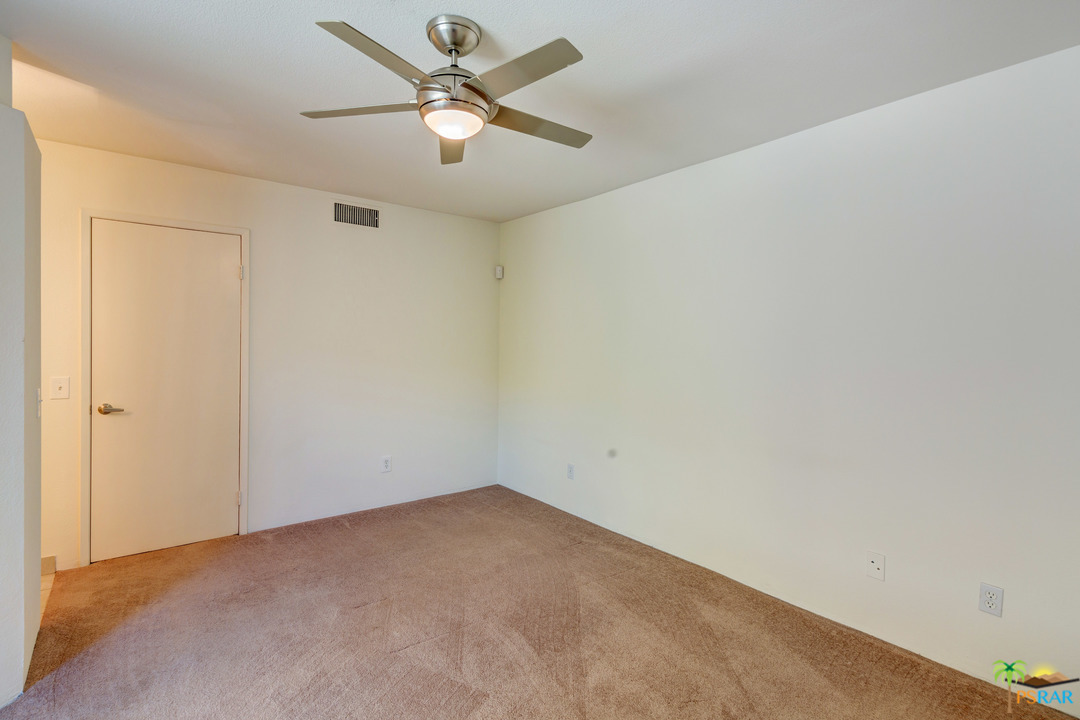 100 East Stevens Road, Unit 509 Palm Springs, CA 92262 - Photo 25 of 37 an empty room with a fan & a ceiling fan