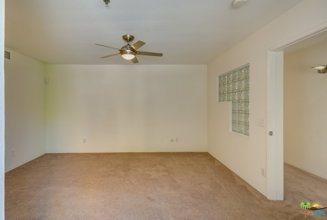 100 East Stevens Road, Unit 509 Palm Springs, CA 92262 - Photo 28 of 37 an empty room with a window and a ceiling fan