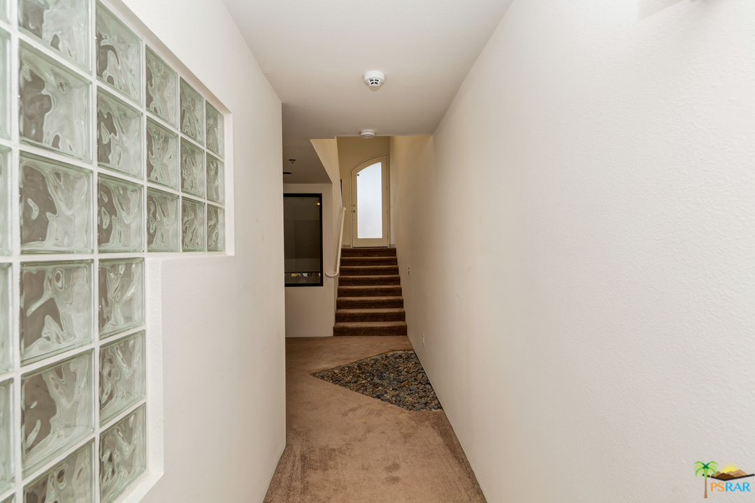 100 East Stevens Road, Unit 509 Palm Springs, CA 92262 - Photo 32 of 37 a view of a hallway with stairs and wooden floor