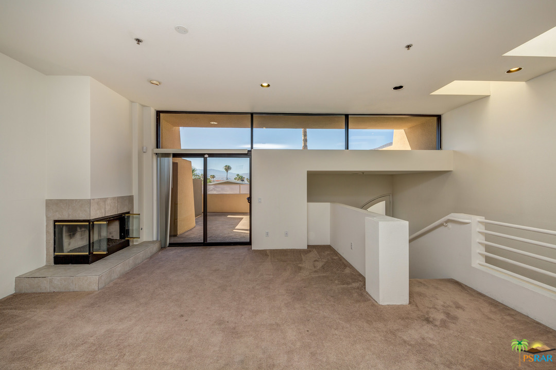 100 East Stevens Road, Unit 509 Palm Springs, CA 92262 - Photo 6 of 37 a view of an empty room with a fireplace and a window