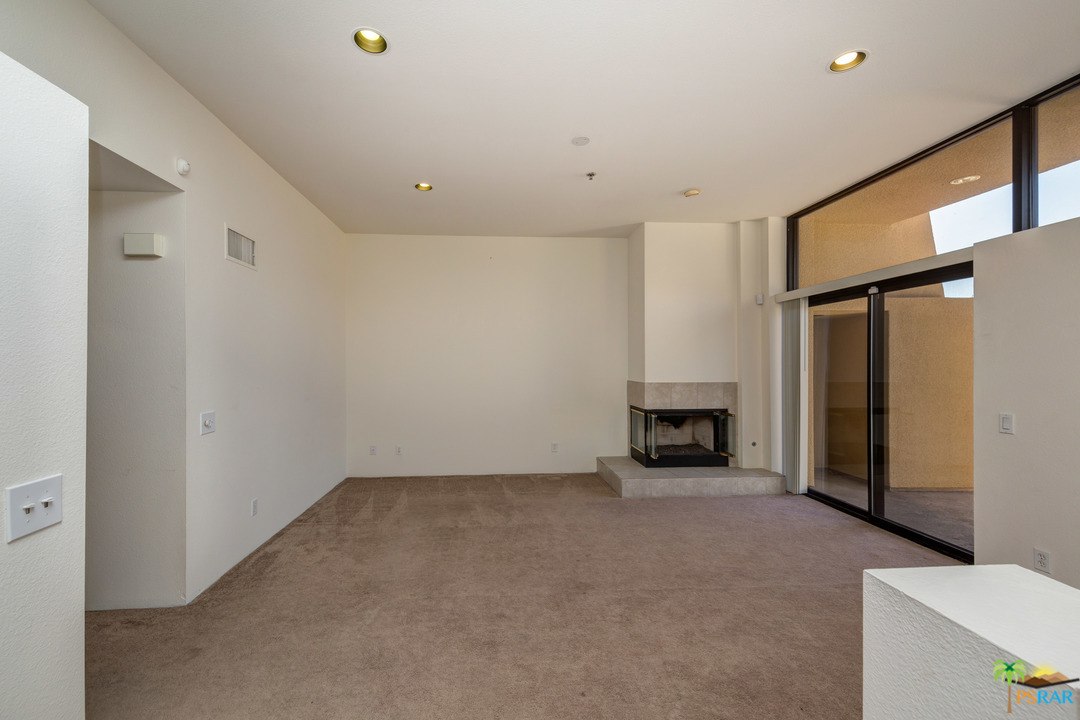 100 East Stevens Road, Unit 509 Palm Springs, CA 92262 - Photo 7 of 37 a view of an empty room with a fireplace