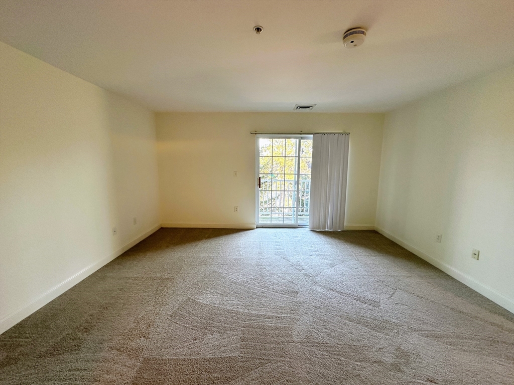 318 Rindge Avenue, Unit 216 Cambridge, MA 02140 - Photo 8 of 15 an empty room with windows