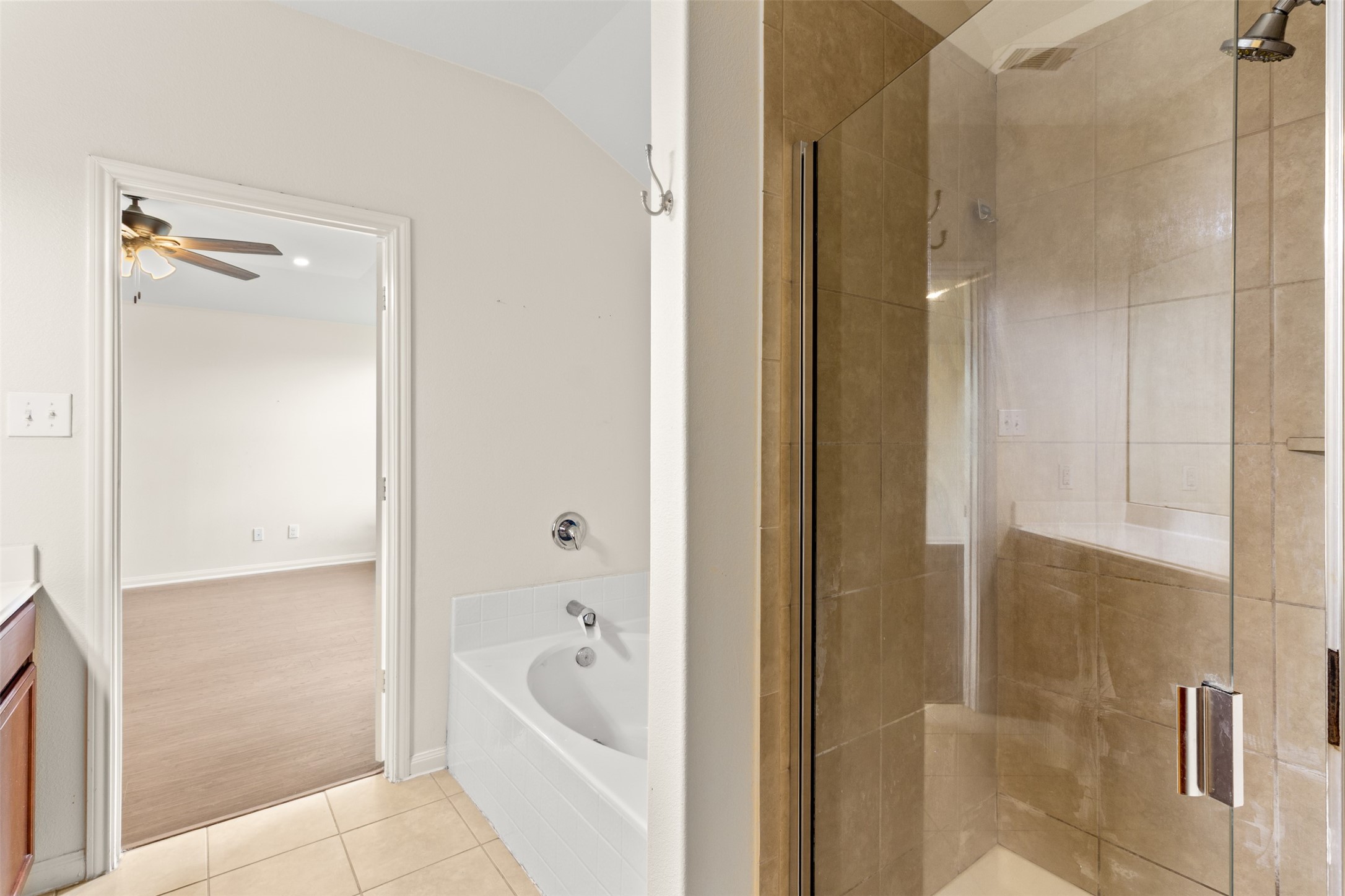 9426 Grand Spark Drive Rosharon, TX 77583 - Photo 17 of 31 Relax and recharge in the spacious soaking tub after a long day, or enjoy the convenience of the separate tiled glass-enclosed shower.
