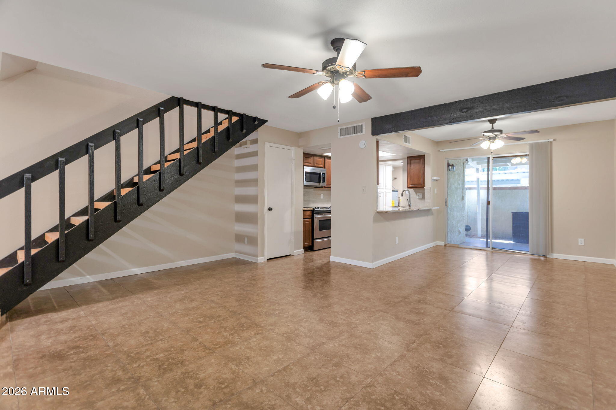 6540 North 7th Avenue, Unit 42 Phoenix, AZ 85013 - Photo 1 of 18 a view of an empty room with wooden floor and staircase