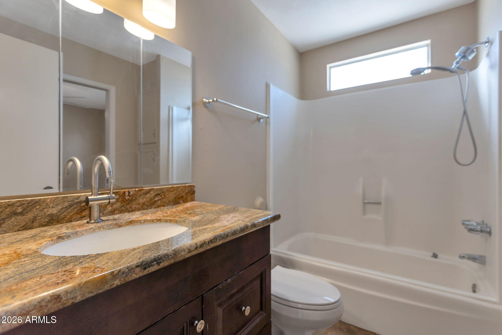 6540 North 7th Avenue, Unit 42 Phoenix, AZ 85013 - Photo 11 of 18 a bathroom with a granite countertop sink a toilet and shower