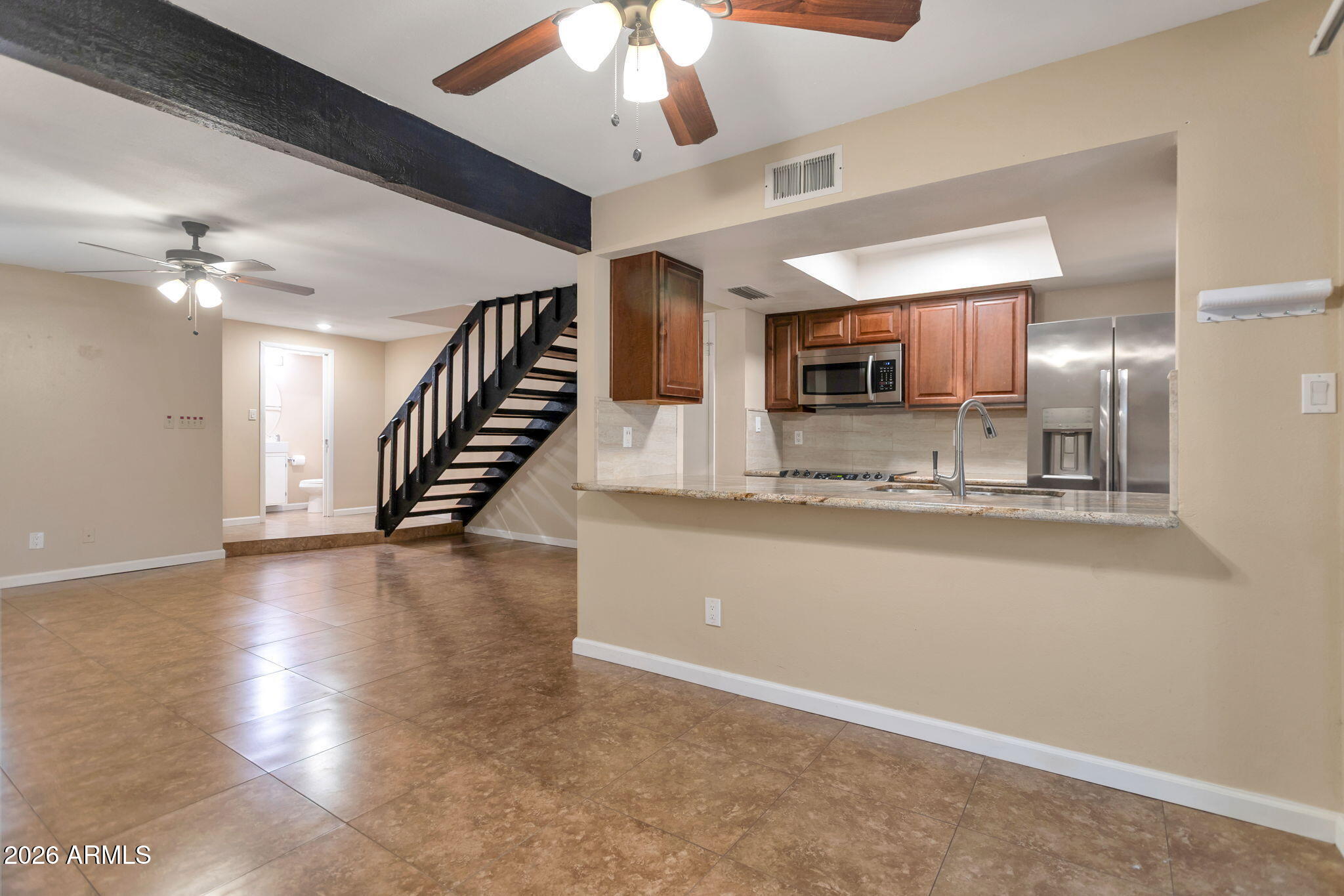 6540 North 7th Avenue, Unit 42 Phoenix, AZ 85013 - Photo 3 of 18 a view of a kitchen with a stove and a chandelier fan