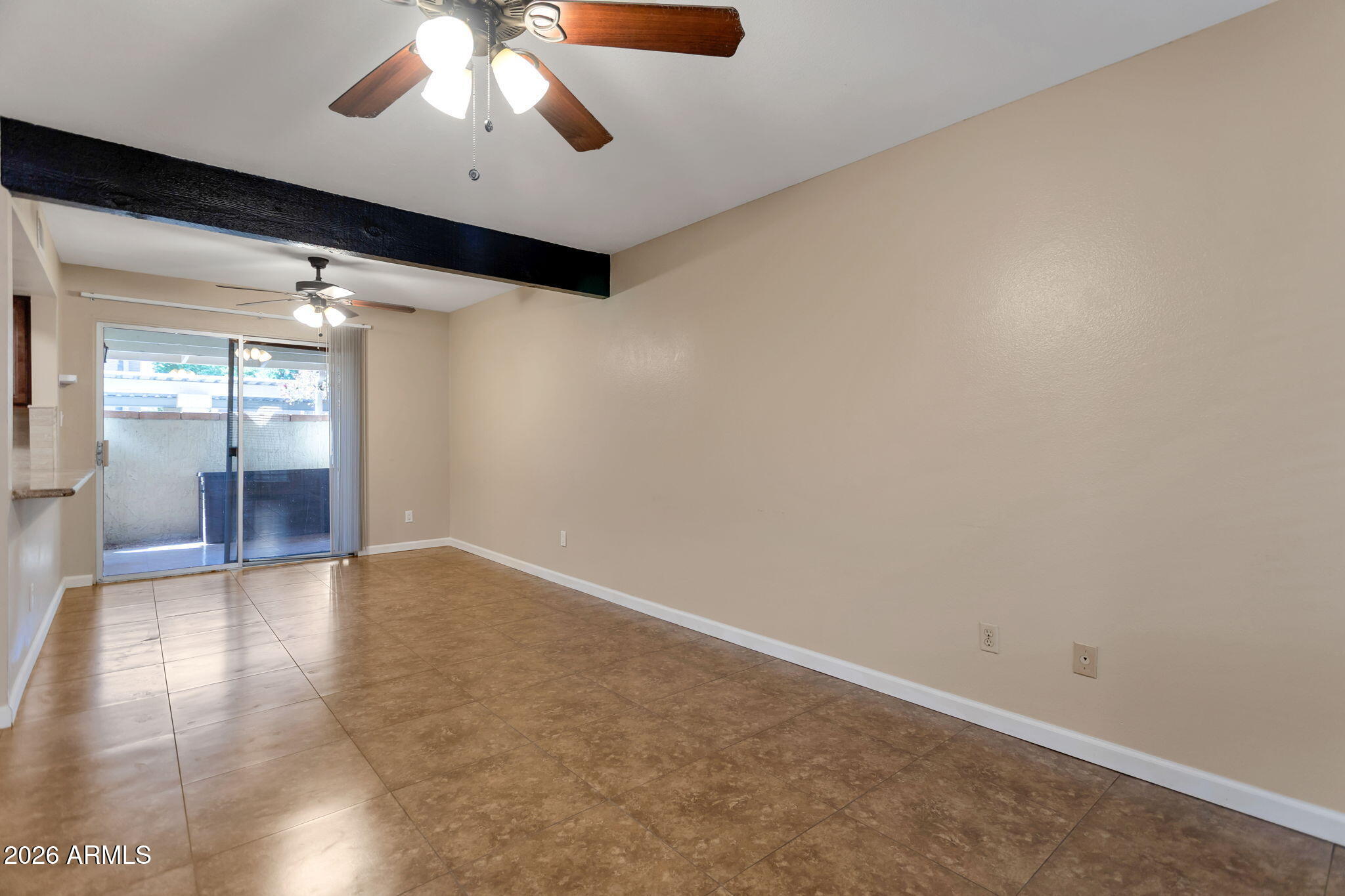 6540 North 7th Avenue, Unit 42 Phoenix, AZ 85013 - Photo 4 of 18 an empty room with wooden floor and windows