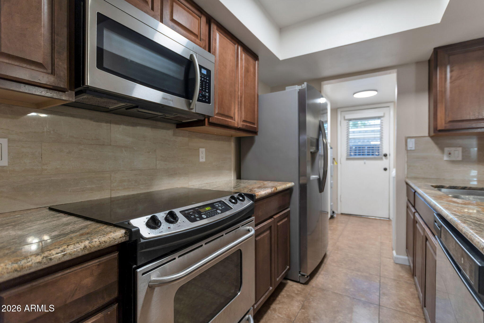 6540 North 7th Avenue, Unit 42 Phoenix, AZ 85013 - Photo 6 of 18 a kitchen with a stove and a microwave