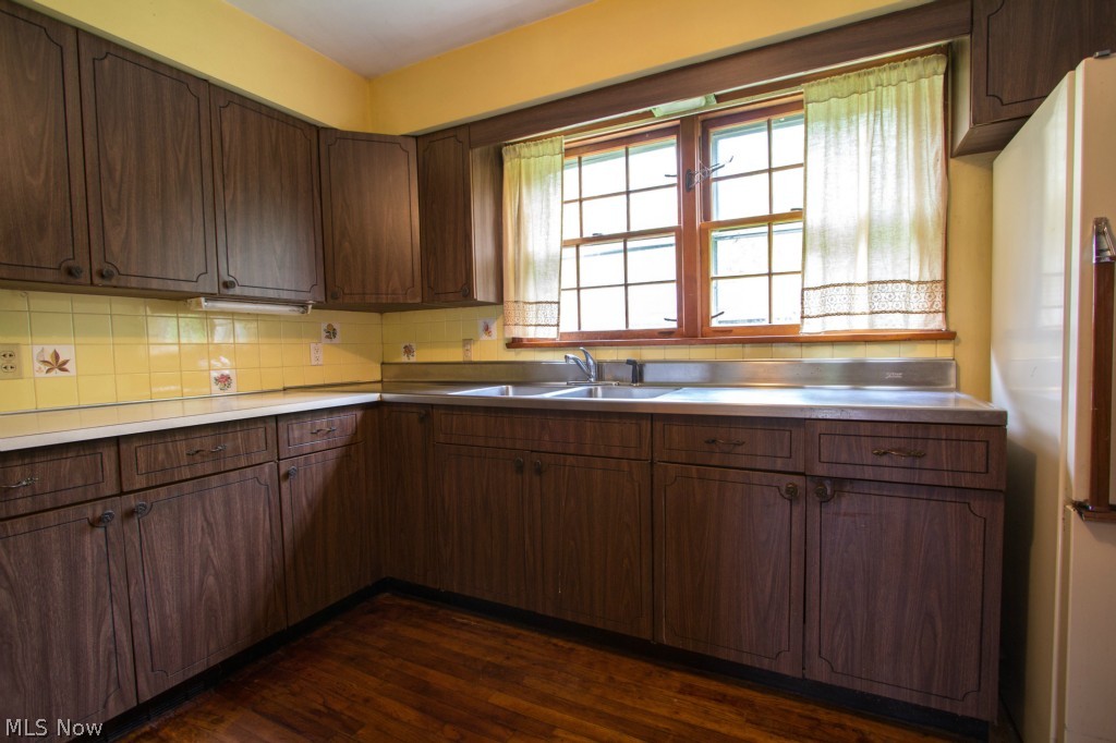 5892 Taylor Road Painesville, OH 44077 - Photo 13 of 25 Spacious kitchen features tile backsplash and a window overlooking the gorgeous property.