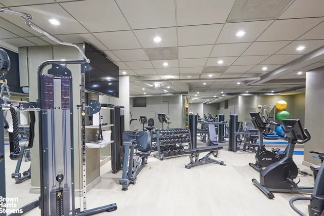 a roof deck with outdoor seating and city view